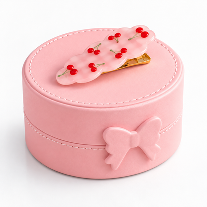 Boîte à bijoux ronde rose fermée avec décoration fantaisie